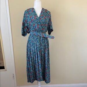 Floral print dress with pleated skirt bottom. Includes a belt
